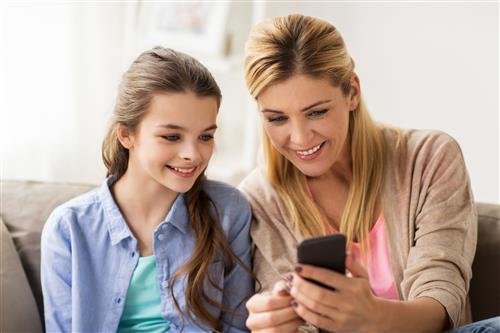 Mom and daughter looking at phone 